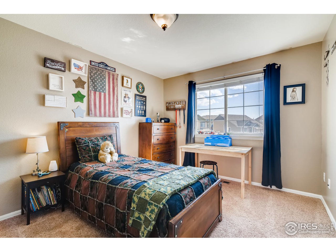 7501 21st Street Greeley, CO 80634 - Photo 24 of 27 a bedroom with a bed wooden floor and a large window