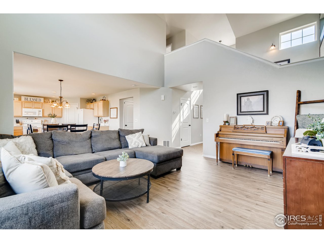 7501 21st Street Greeley, CO 80634 - Photo 3 of 27 a living room with furniture and a wooden floor