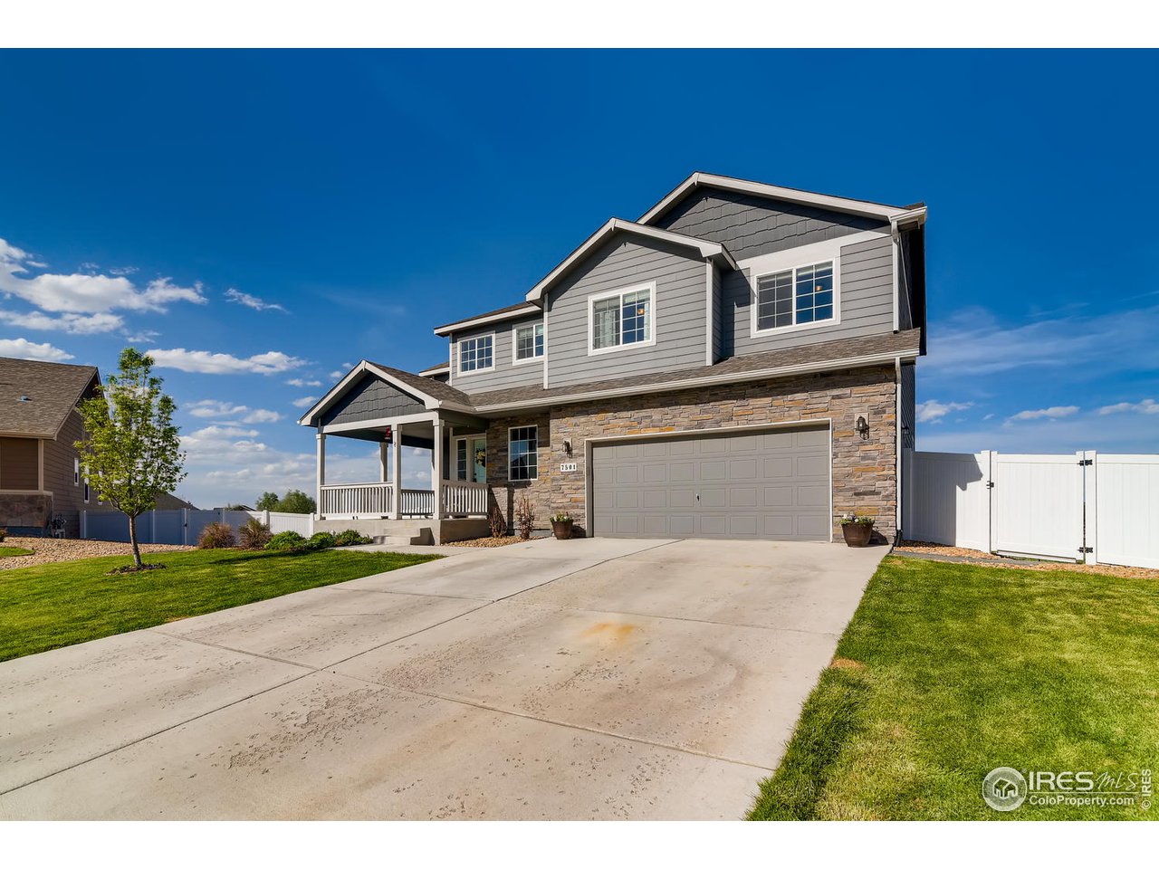 7501 21st Street Greeley, CO 80634 - Photo 5 of 27 a front view of a house with a yard