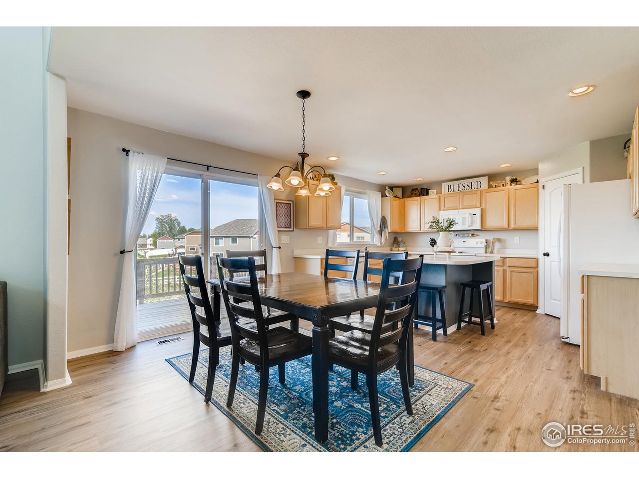 7501 21st Street Greeley, CO 80634 - Photo 10 of 27 a view of a dining room with furniture window and wooden floor