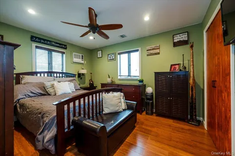 a bedroom with furniture and wooden floor