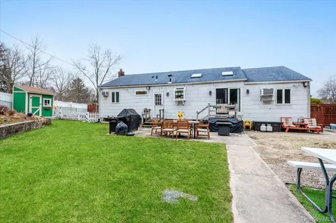a view of a yard with table and chairs under an umbrella