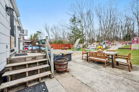 a view of a chairs and tables in the back yard of the house