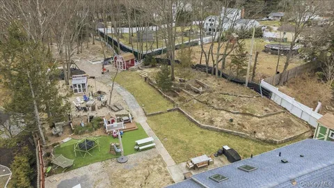 an aerial view of a house with a yard