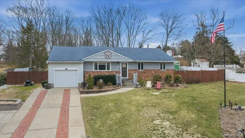 a front view of a house with patio and garden