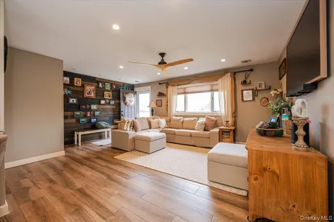 a living room with fireplace furniture and a flat screen tv