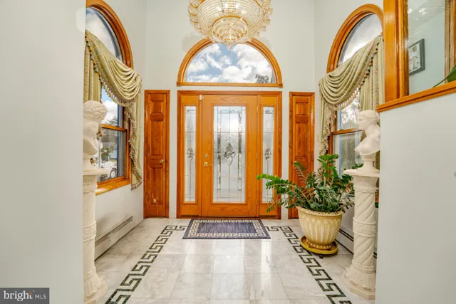 a bedroom with a bed and a table with the outer view