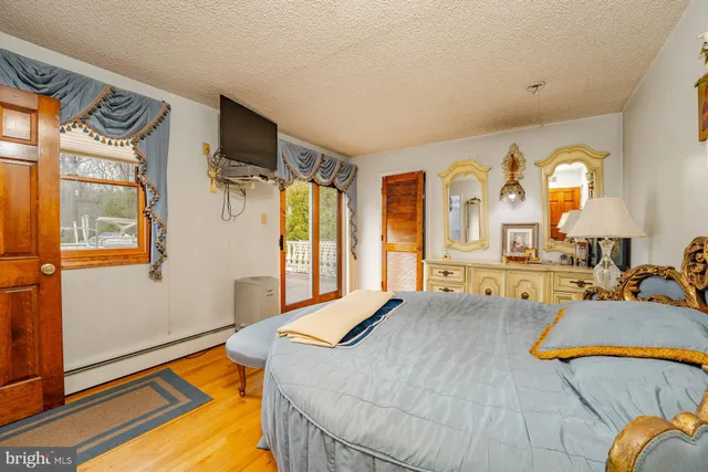 a bathroom with a granite countertop sink a toilet and a shower