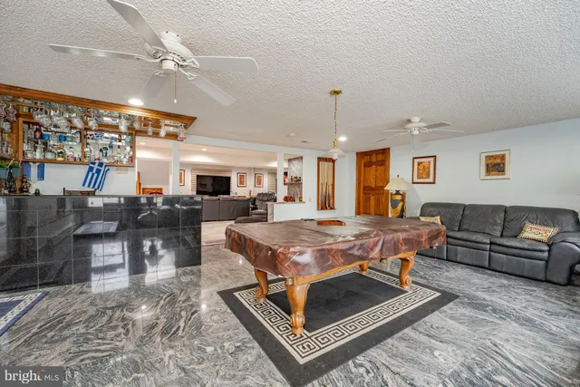 a dining room with furniture and a chandelier