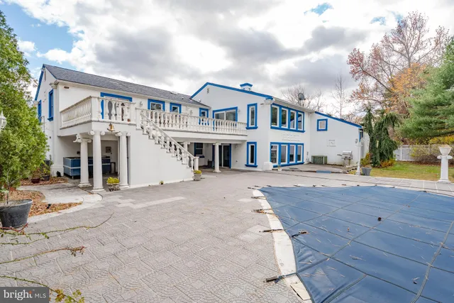 a front view of a building with cars parked