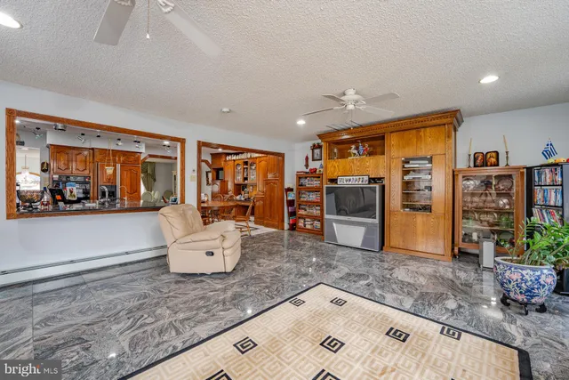 a view of kitchen with stainless steel appliances granite countertop lots of counter top space