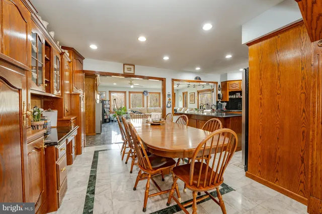 a view of a kitchen with stainless steel appliances granite countertop a sink and a counter top space
