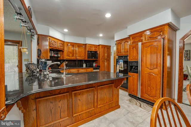 a kitchen with stainless steel appliances granite countertop a sink and cabinets