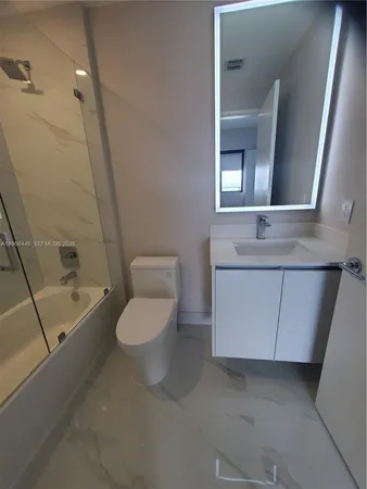 a bathroom with a toilet tub and a shower