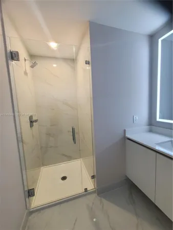 a bathroom with a sink and a large mirror