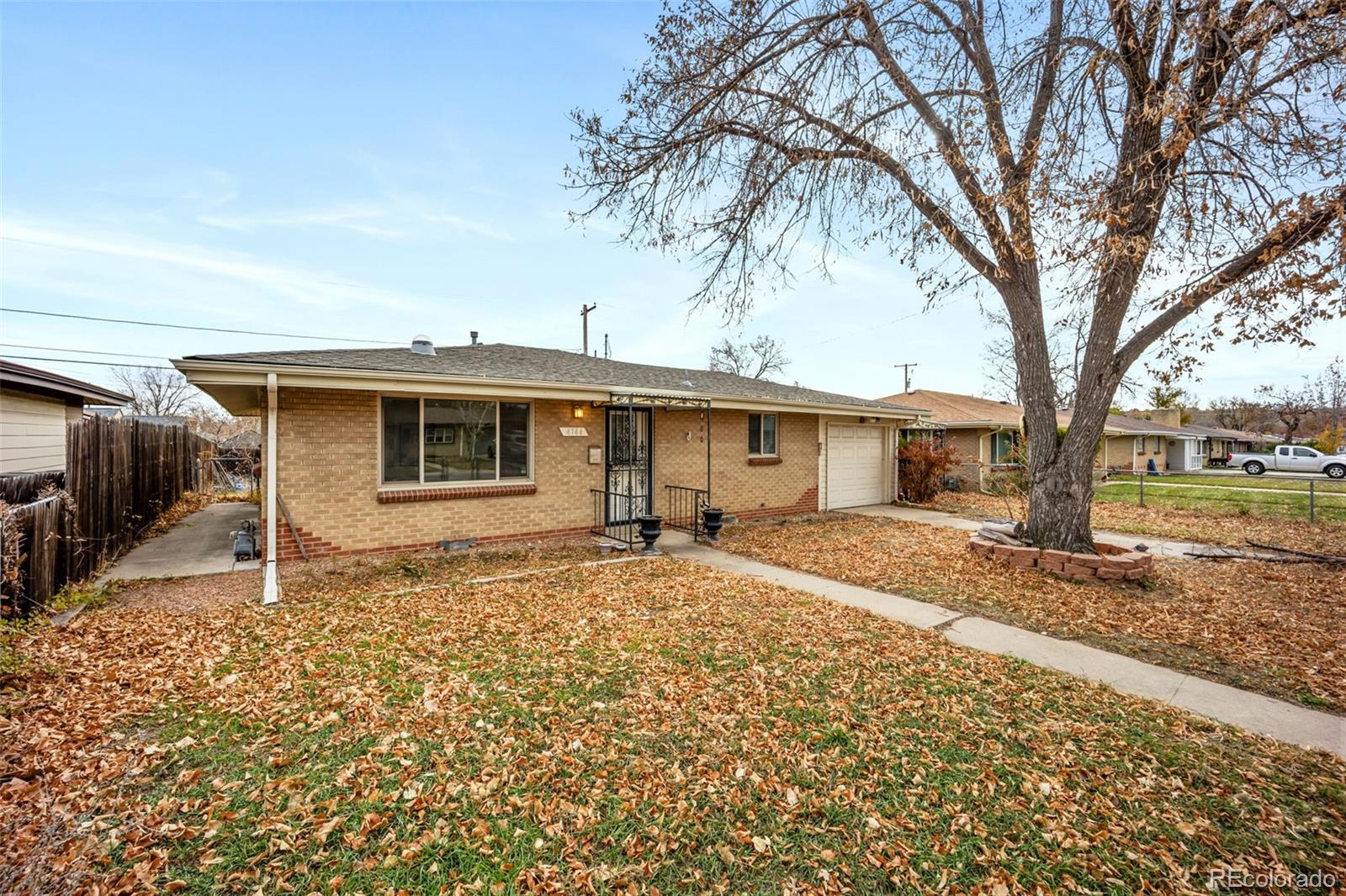 4744 Dudley Street Wheat Ridge, CO 80033 - Photo 1 of 16 a front view of a house with a yard