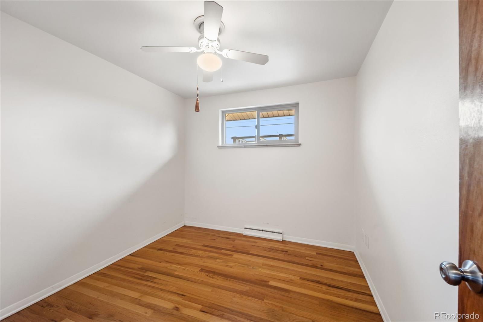 4744 Dudley Street Wheat Ridge, CO 80033 - Photo 13 of 16 a view of a room with wooden floor