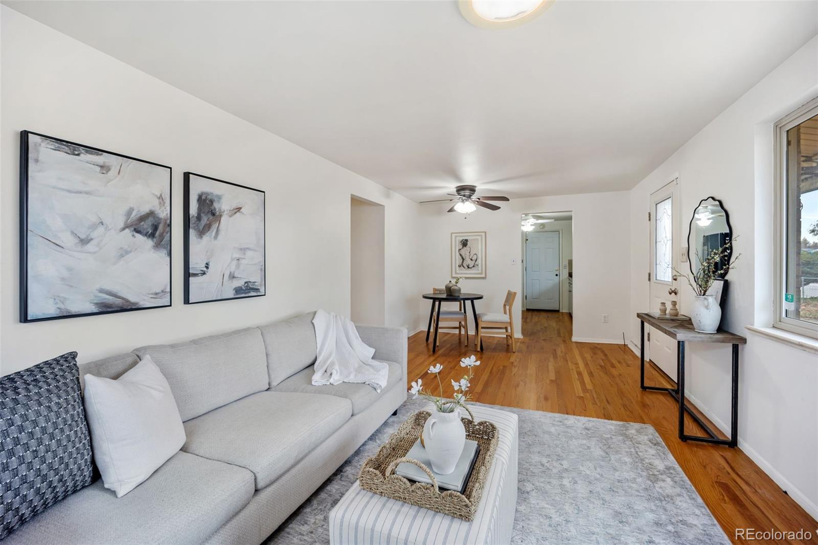 4744 Dudley Street Wheat Ridge, CO 80033 - Photo 4 of 16 a living room with furniture and a chandelier