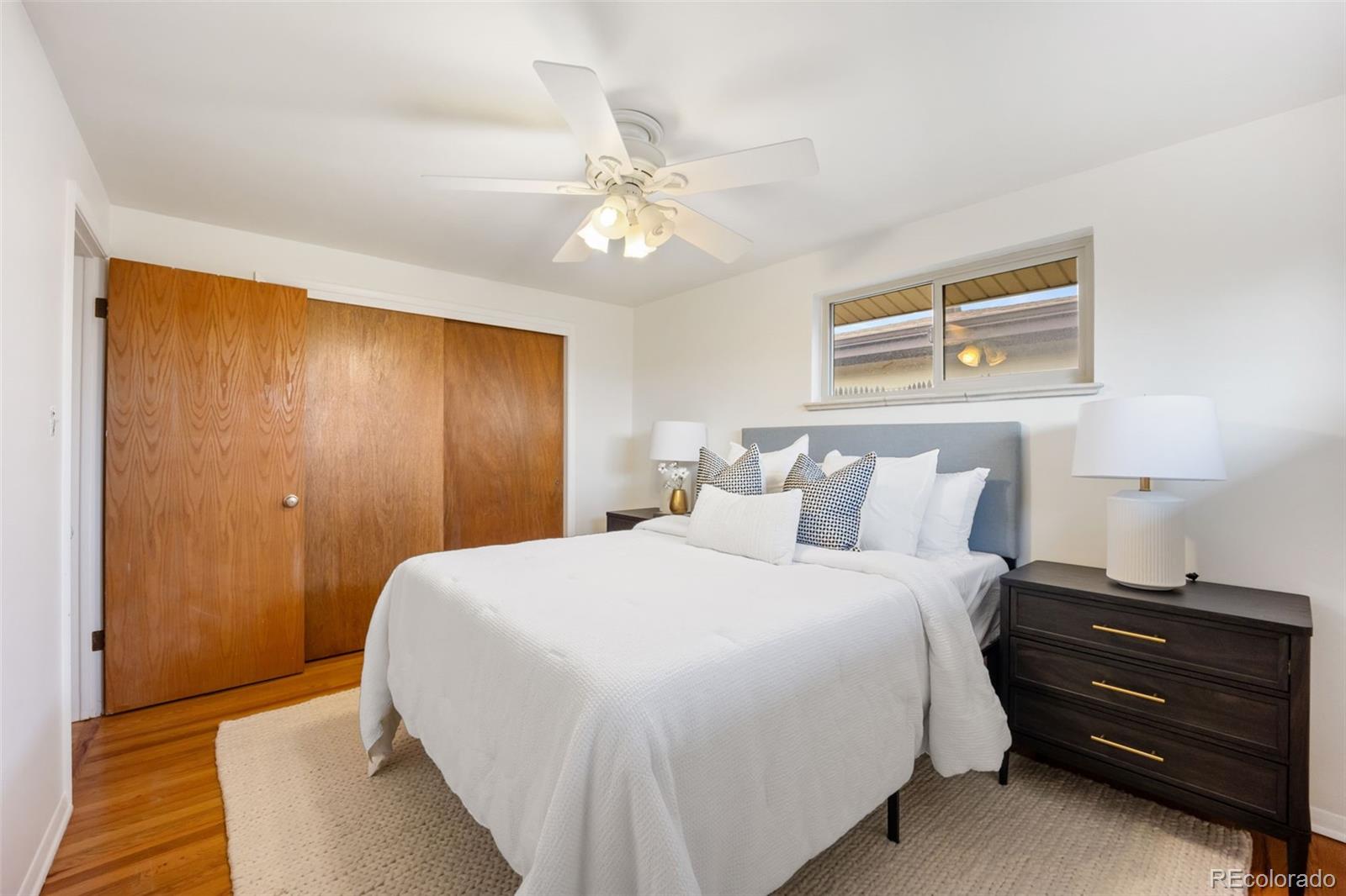 4744 Dudley Street Wheat Ridge, CO 80033 - Photo 9 of 16 a bedroom with a bed and a chandelier
