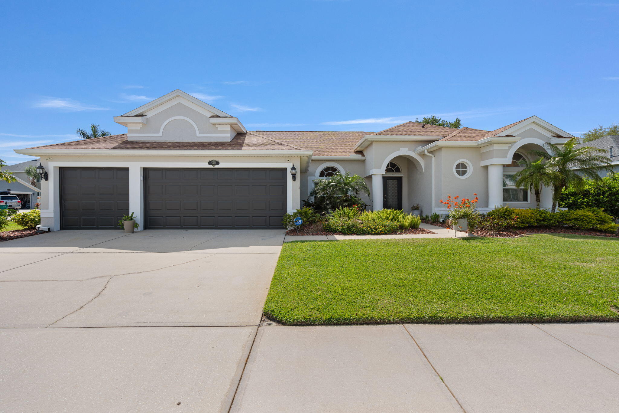 a front view of a house with a yard and garage