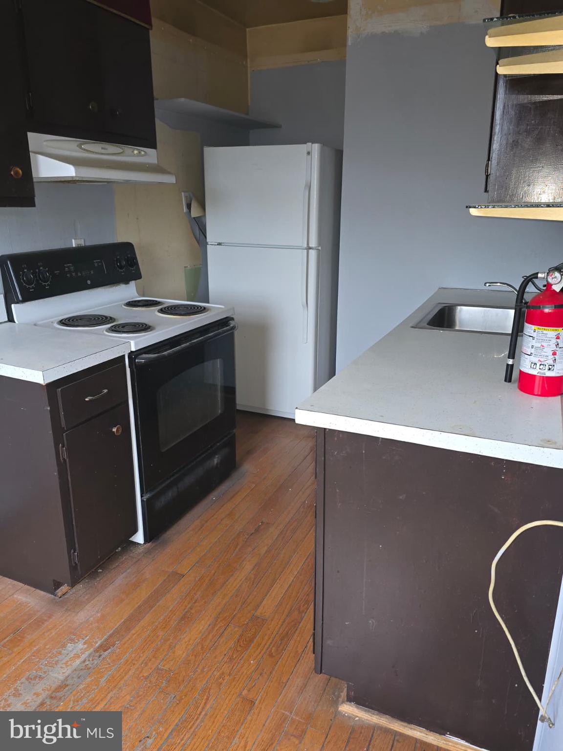428 Ridge Road Southeast, Unit 305 Washington, DC 20019 - Photo 13 of 23 a kitchen with a wooden floor and cabinets