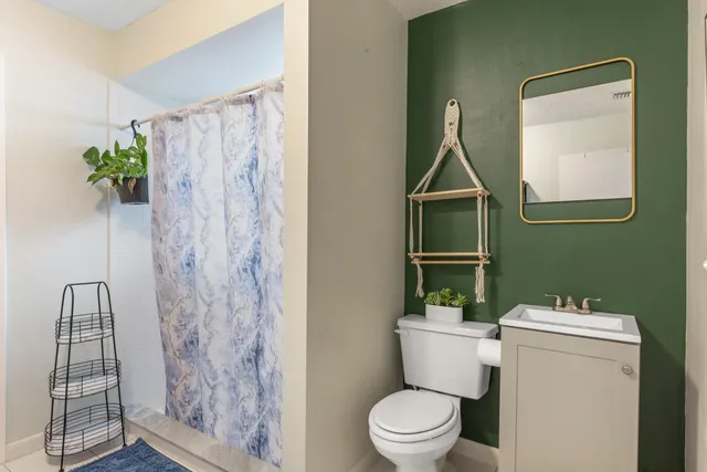 a bathroom with a toilet and a shower