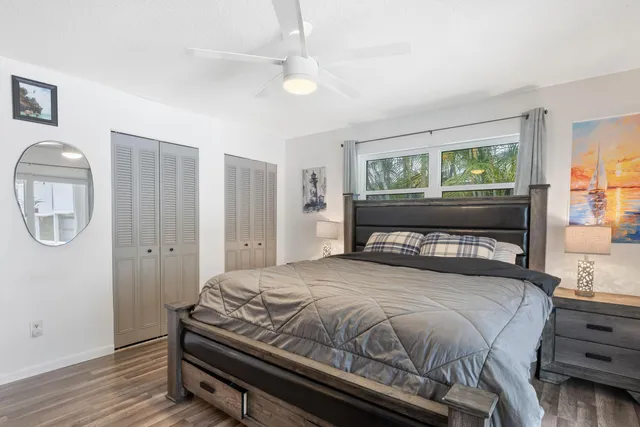 a bedroom with a bed mirror and window