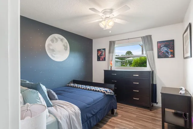 a bedroom with a bed and a chandelier