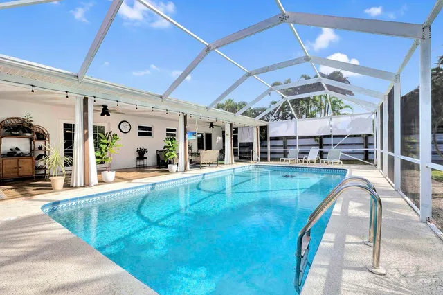 a view of a swimming pool with an outdoor seating