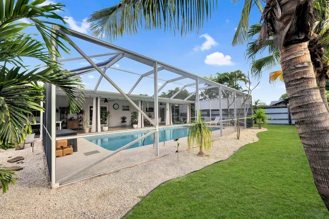 a view of a house with a yard and sitting area