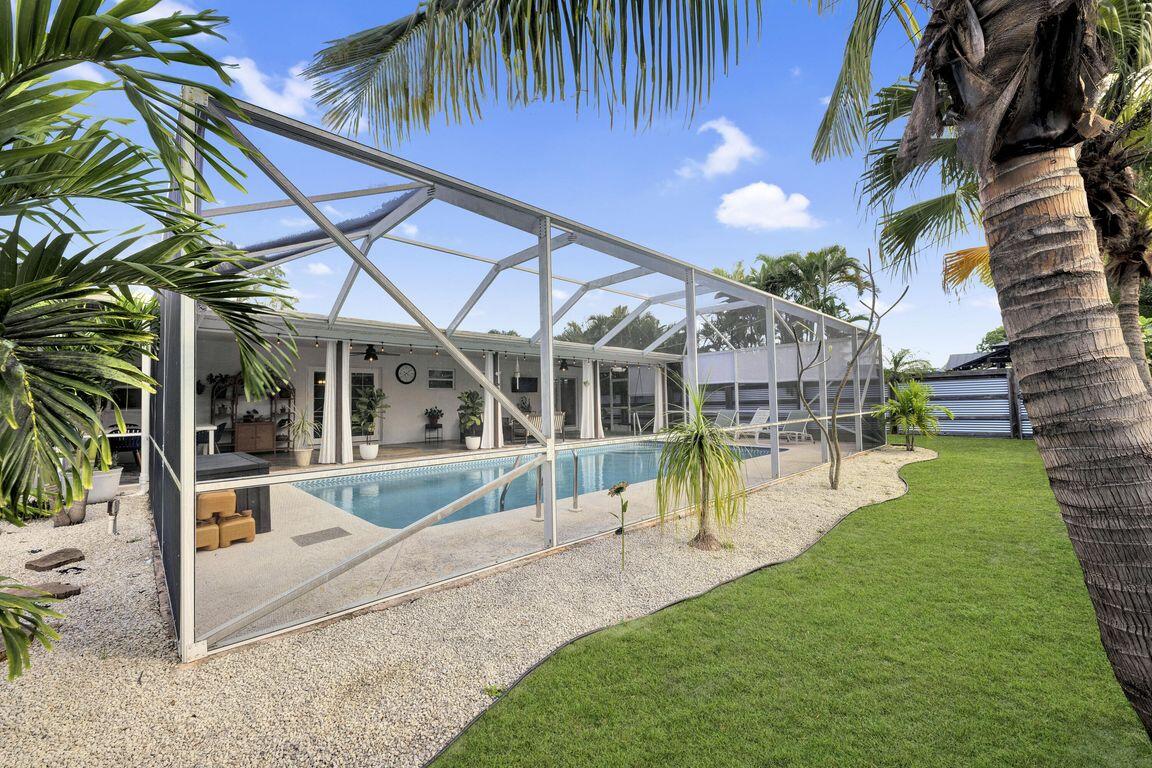 1104 Northwest 12th Terrace Stuart, FL 34994 - Photo 27 of 32 a view of a house with a yard and sitting area