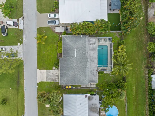 an aerial view of a house with a yard