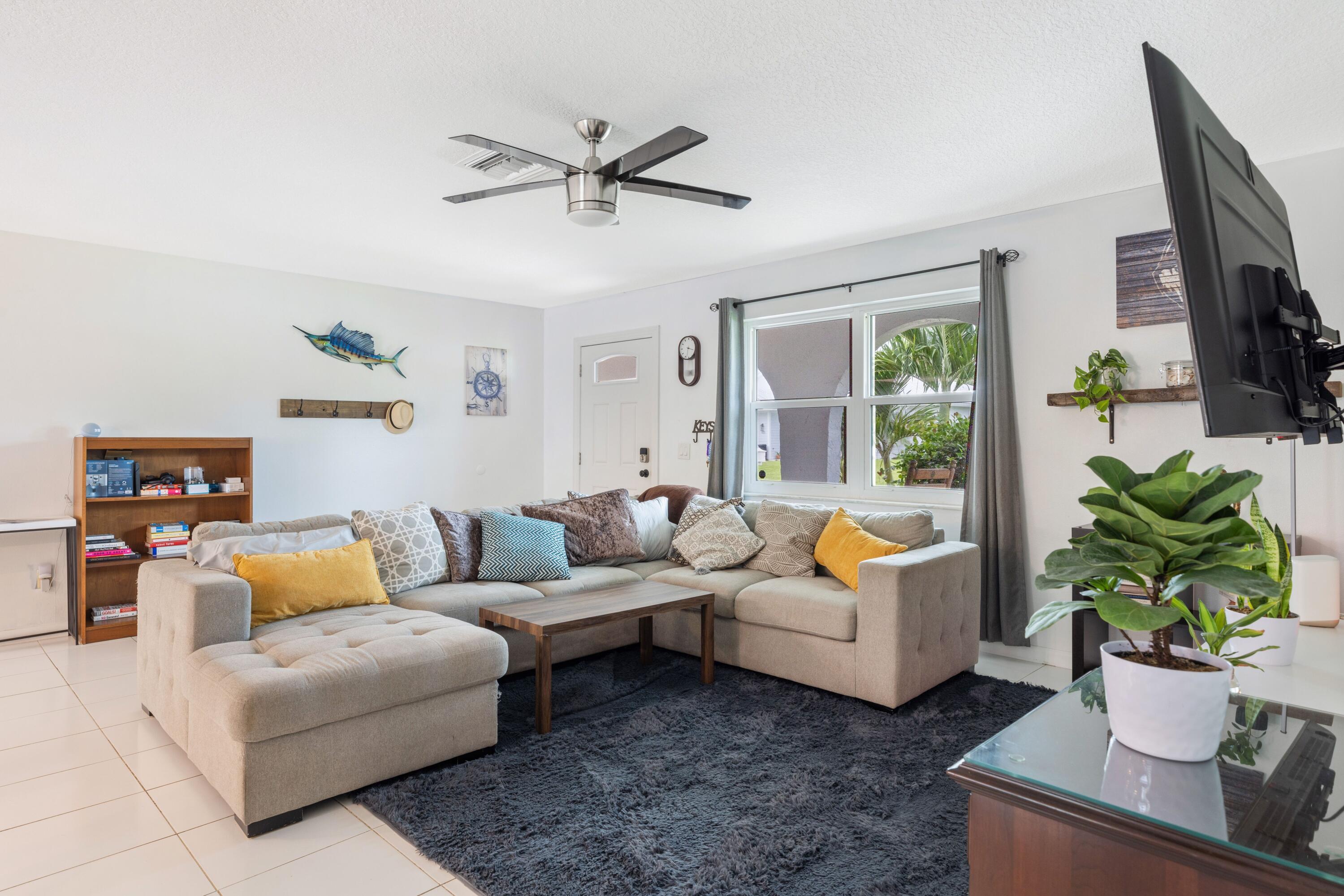 1104 Northwest 12th Terrace Stuart, FL 34994 - Photo 6 of 32 a living room with furniture and a large window