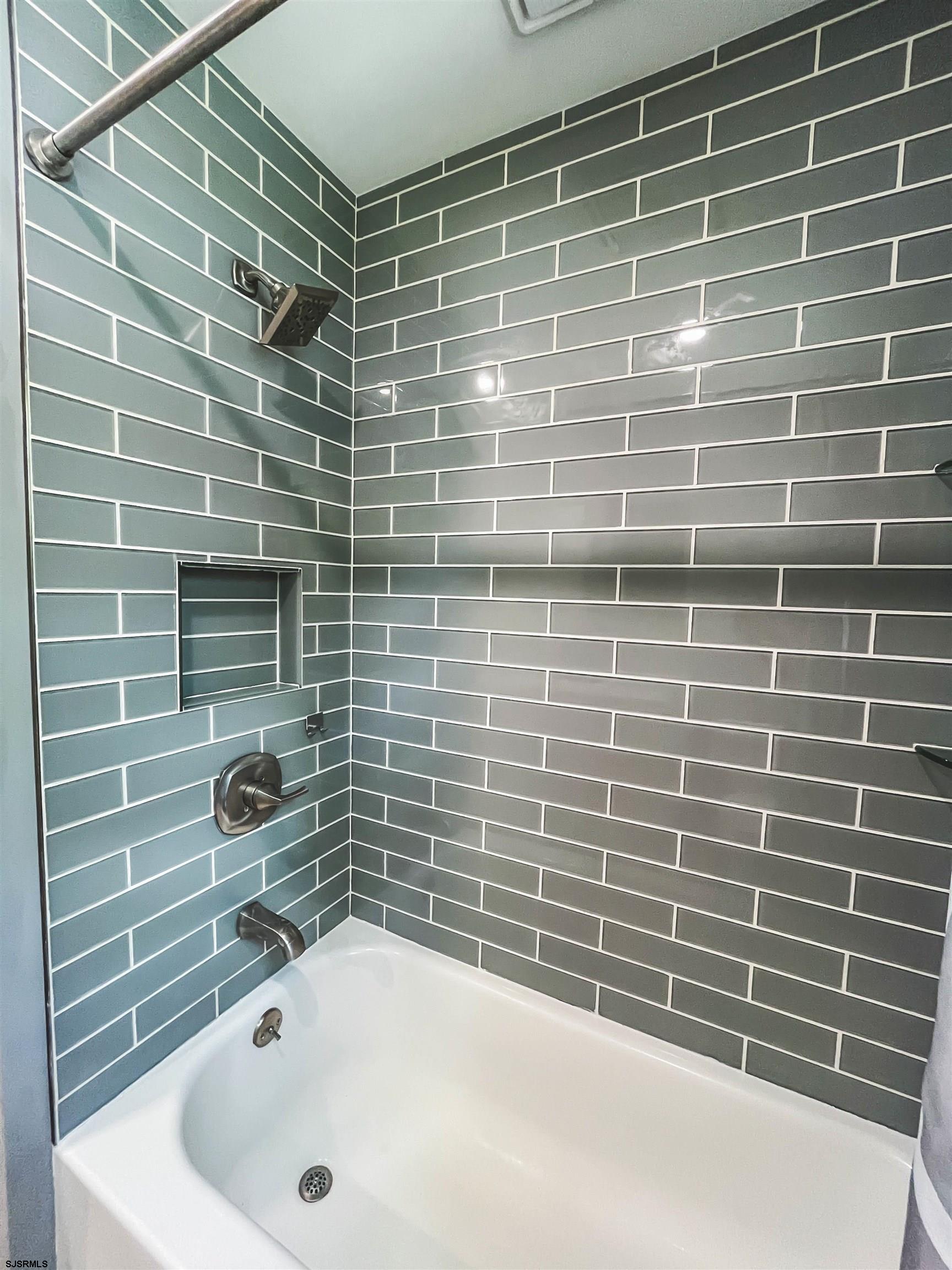 518 Delaware Avenue Absecon, NJ 08201 - Photo 20 of 38 a bathroom with a tub and a shower