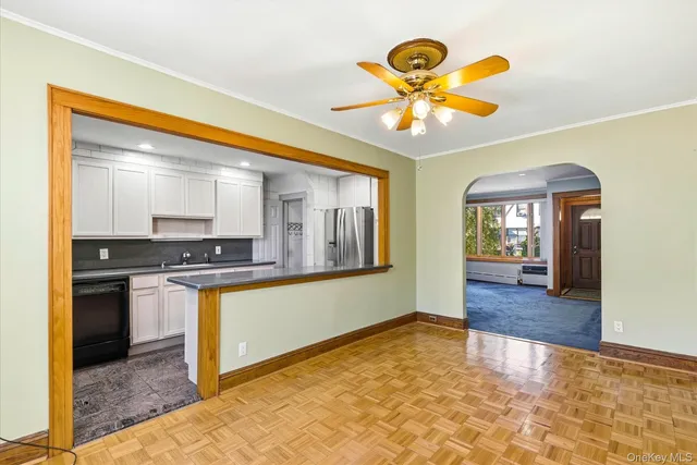 a view of a kitchen with a stove cabinets and a floor to ceiling window