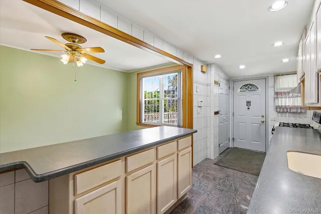 a kitchen with cabinets and window