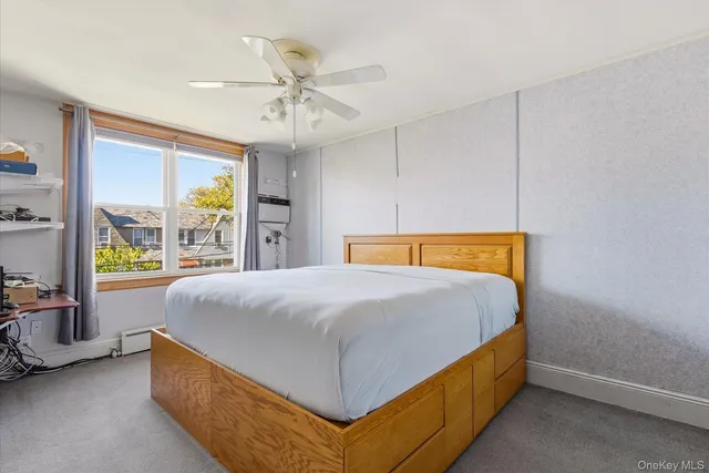 a bed sitting in a spacious bedroom next to a window