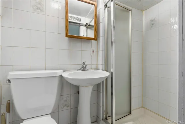 a bathroom with a sink a toilet and mirror