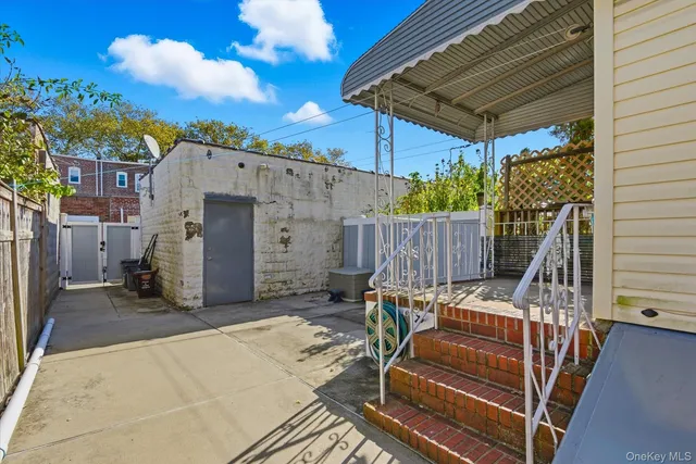 a view of a chair and tables in the back yard of the house
