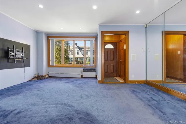 an empty room with windows closet and mirror