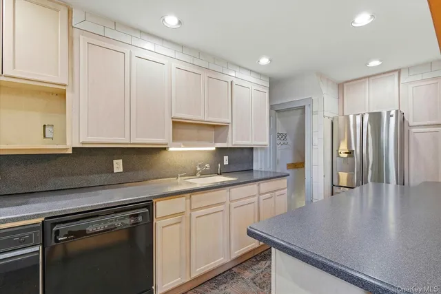 a kitchen with stainless steel appliances granite countertop a refrigerator sink and cabinets
