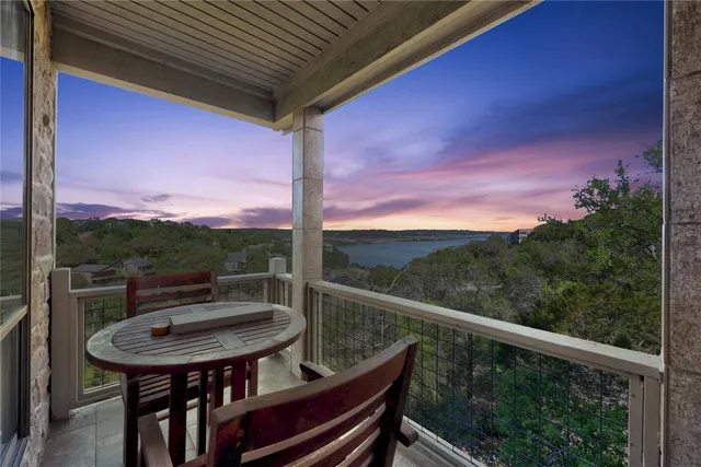 a view of a balcony with a table and chairs