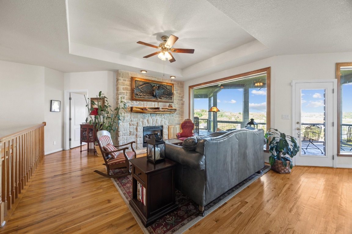 515 Coventry Road Spicewood, TX 78669 - Photo 11 of 36 a living room with furniture and a fireplace