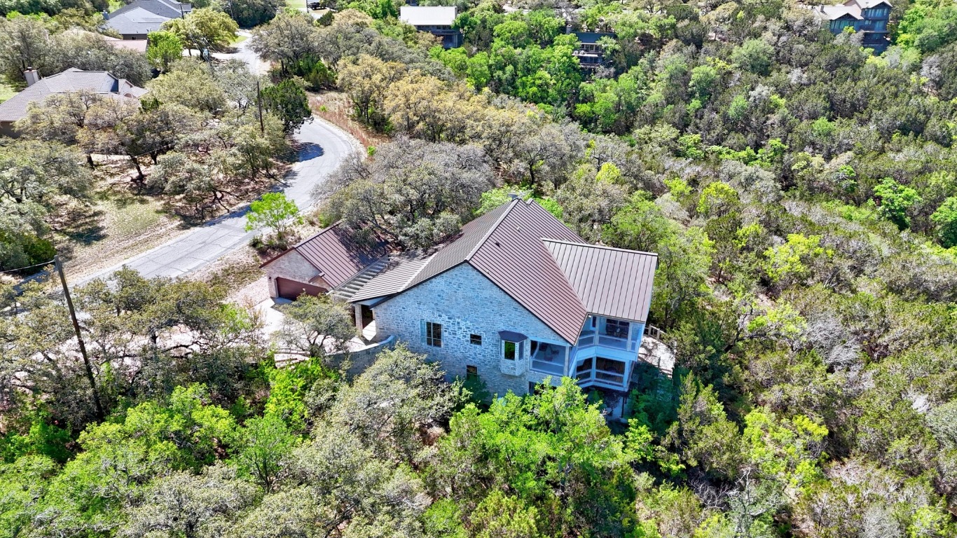 515 Coventry Road Spicewood, TX 78669 - Photo 16 of 36 an aerial view of a house with a yard and large trees