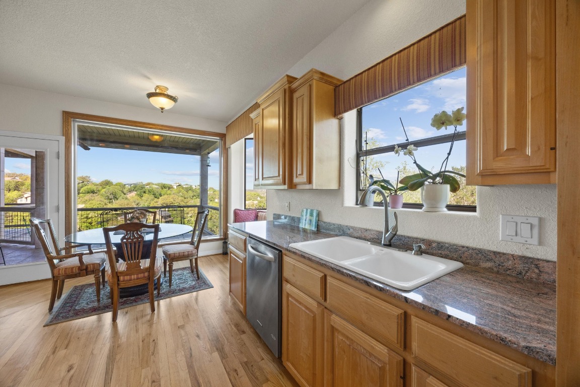 515 Coventry Road Spicewood, TX 78669 - Photo 18 of 36 a kitchen with a table chairs and wooden floor