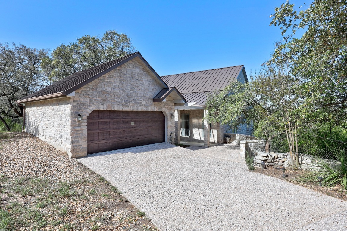 515 Coventry Road Spicewood, TX 78669 - Photo 2 of 36 a front view of a house with yard and garage