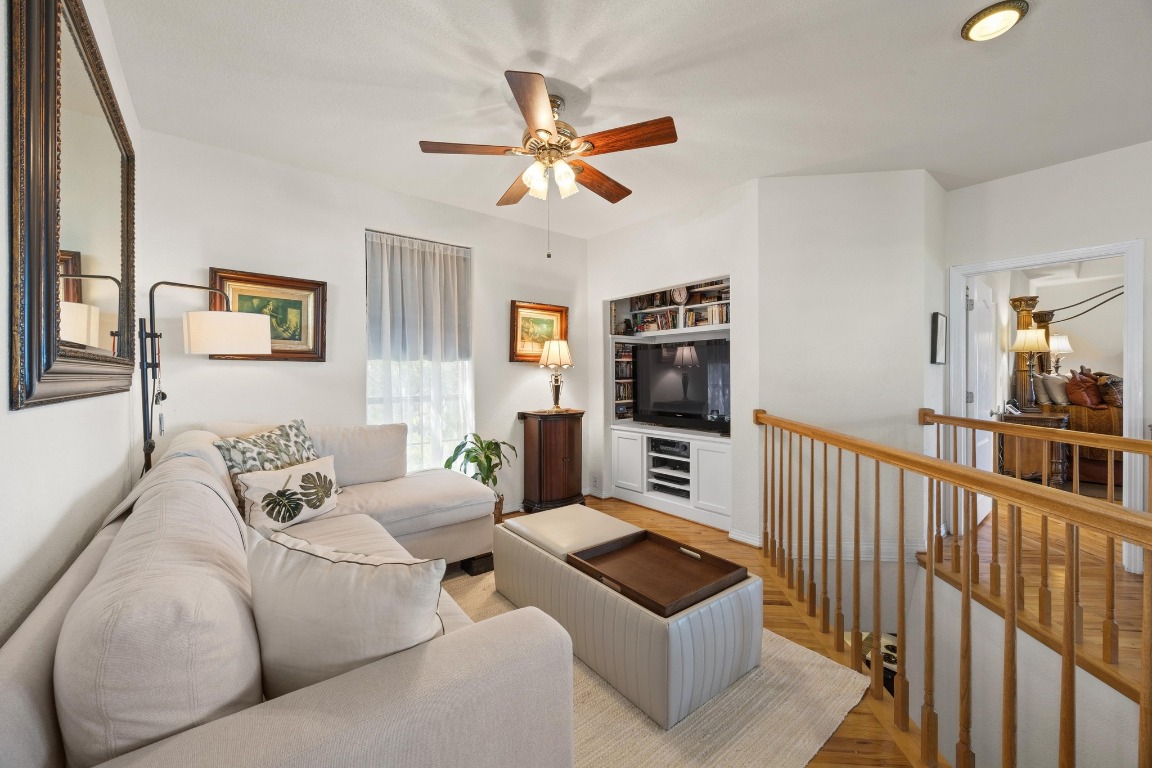 515 Coventry Road Spicewood, TX 78669 - Photo 22 of 36 a living room with furniture a flat screen tv and a window