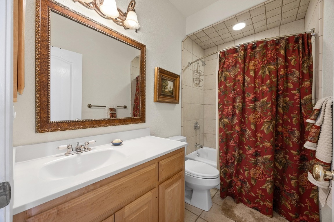 515 Coventry Road Spicewood, TX 78669 - Photo 25 of 36 a bathroom with a sink toilet and shower