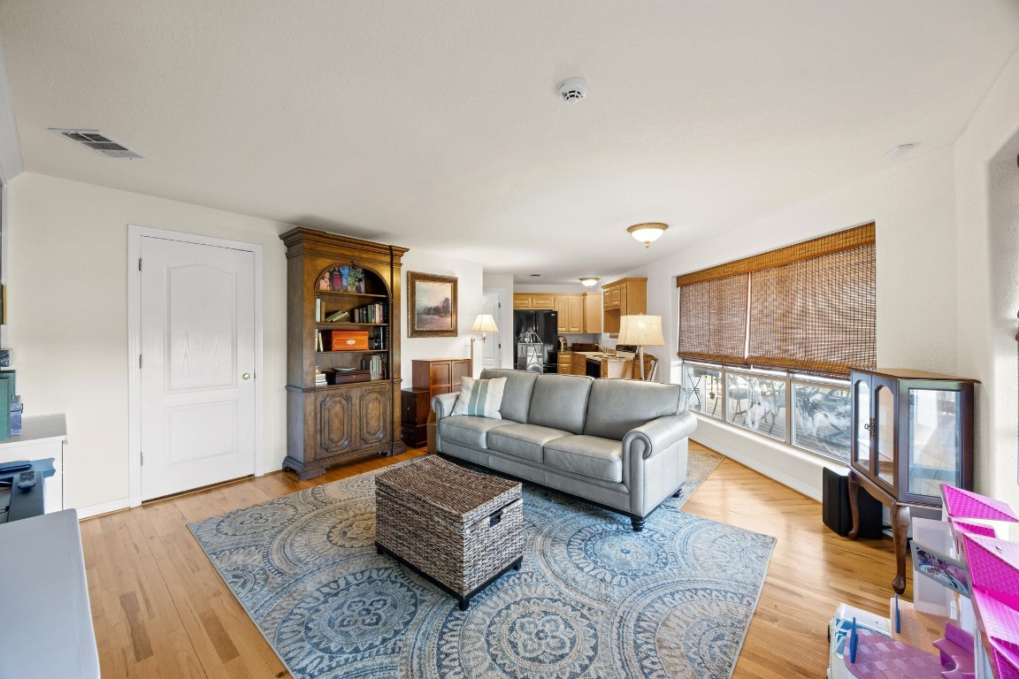 515 Coventry Road Spicewood, TX 78669 - Photo 26 of 36 a living room with furniture and a wooden floor