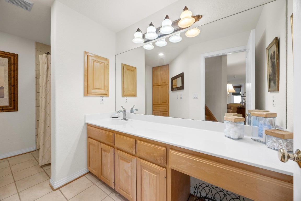 515 Coventry Road Spicewood, TX 78669 - Photo 28 of 36 a bathroom with a sink vanity and mirror